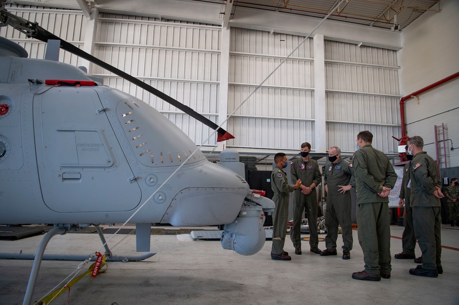 Vice Chief of Naval Operations (VCNO), Adm. Bill Lescher and Sailors assigned to the “Merlins” of Helicopter Sea Combat Squadron (HSC) 3 discuss mission capabilities of the MQ-8C Fire Scout unmanned helicopter.