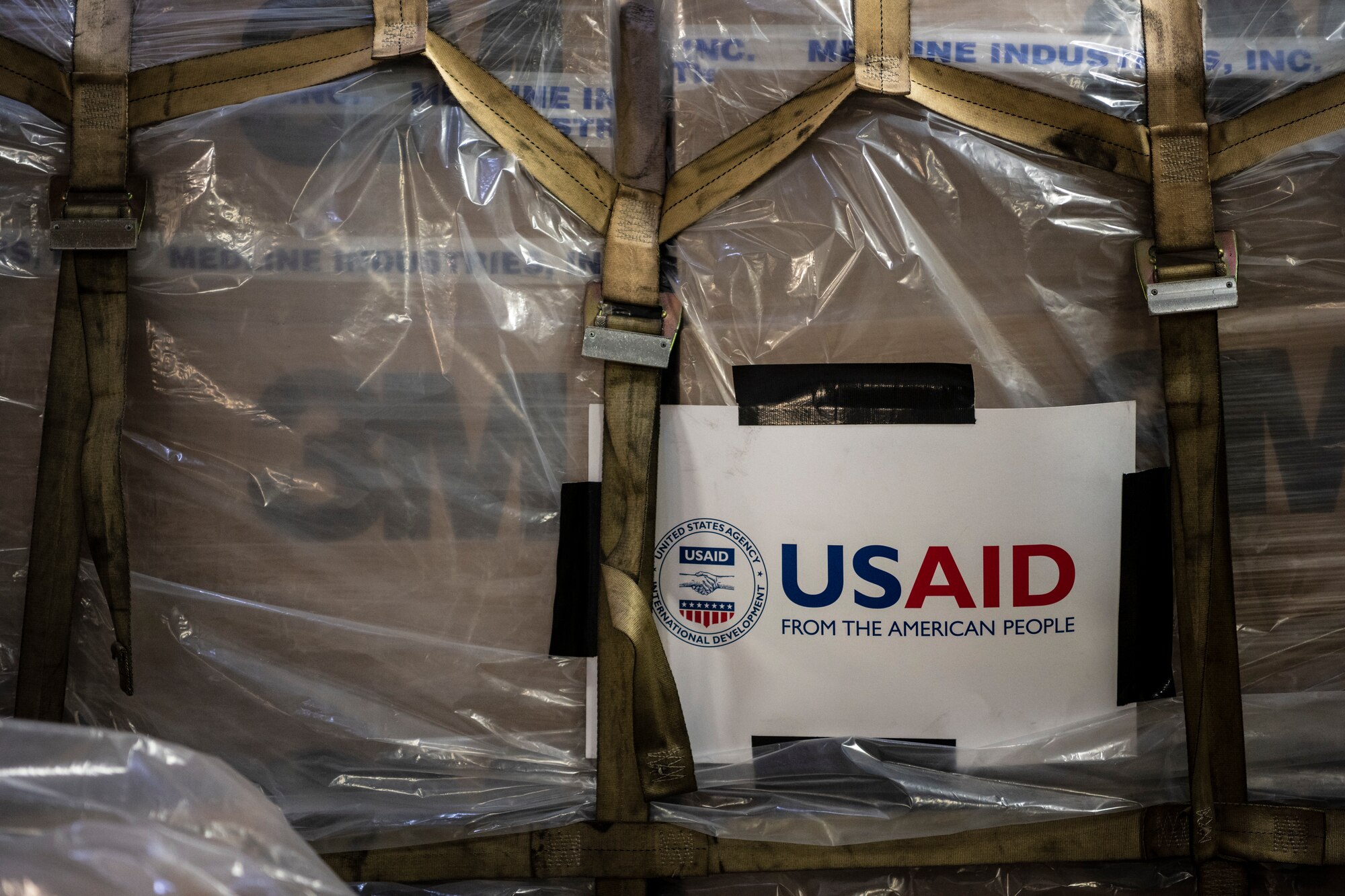 A sign reading USAID is attached to a pallet.