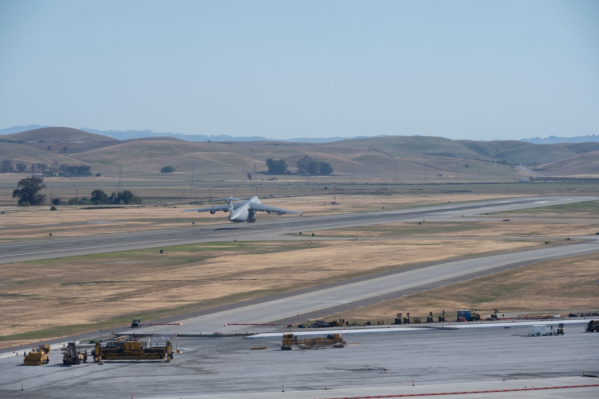 A very very large grey aircraft is seen taking off.