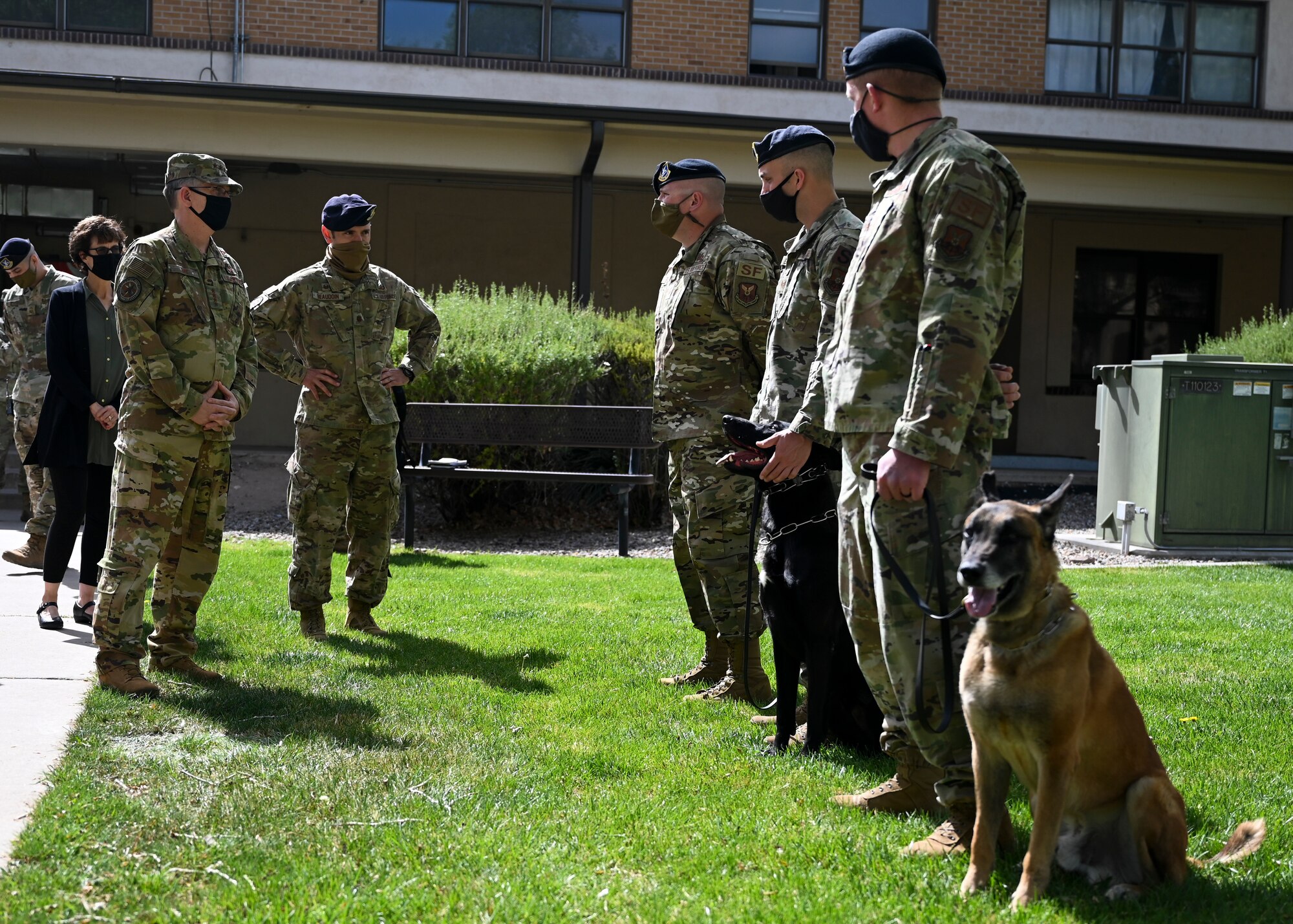 U.S. Air Force Gen. Tim Ray, Air Force Global Strike Command commander, left, meets several military working dogs and their handlers.