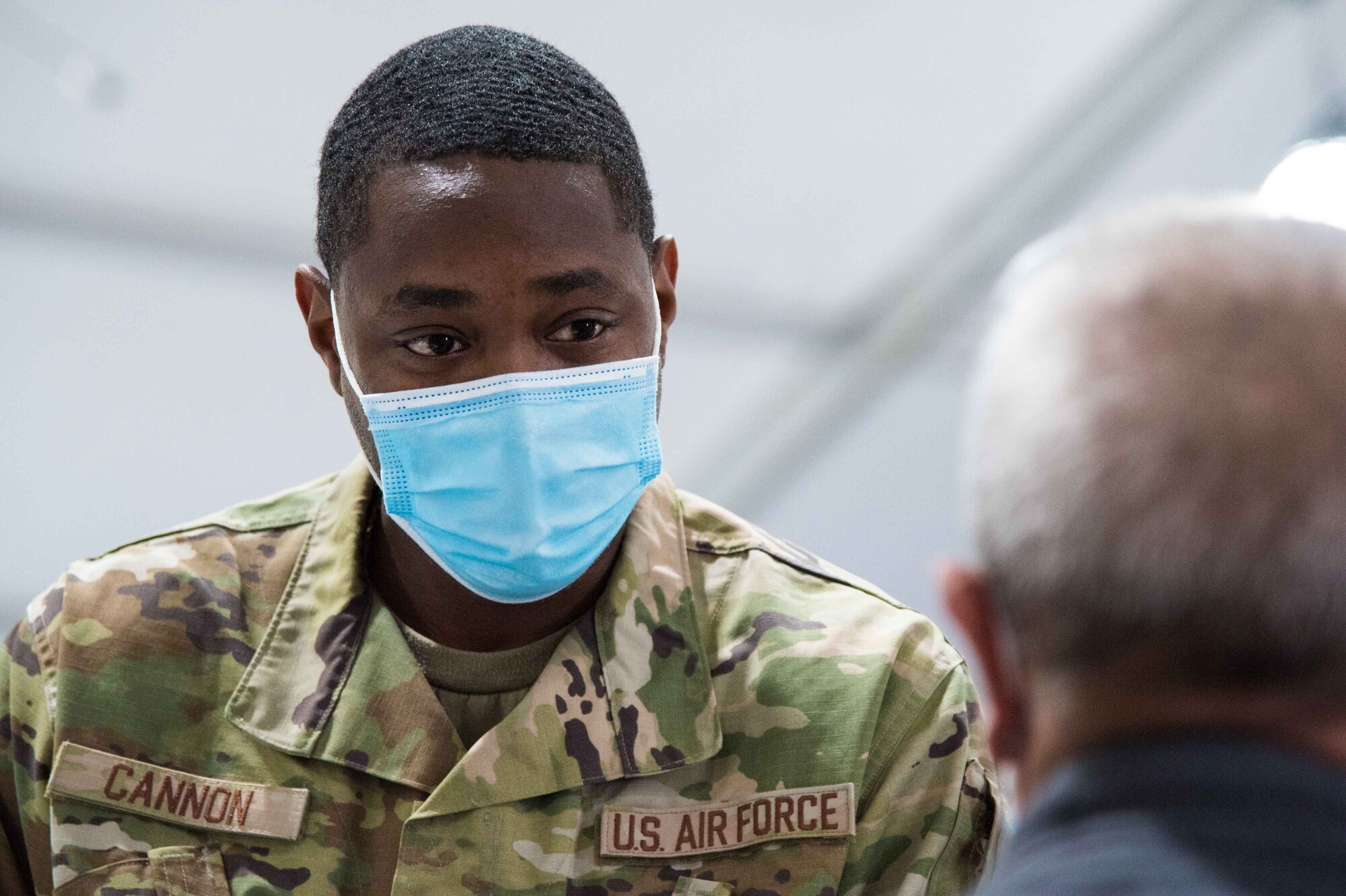 U.S. Air Force Staff Sgt. Quinton Cannon, 628th Medical Group medical technician, preps a patient for their COVID-19 vaccine April 28, 2021, at the Community Vaccination Center (CVC) in St. Paul, Minnesota. The team assisting with the vaccinations range from medical technicians to communication specialists, as well as weather technicians. (U.S. Air Force photo by Senior Airman Alexi Bosarge)