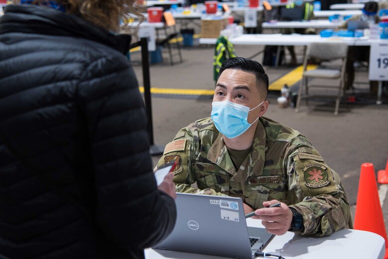 U.S. Air Force Senior Airman Peter Lor, 92nd Medical Group pharmacy technician, collects patient information before a COVID-19 vaccine is administered April 27, 2021, at the Community Vaccination Center (CVC) in St. Paul, Minnesota. The CVC welcomes the St. Paul community to receive free COVID-19 vaccines. U.S. Northern Command, through U.S. Army North, remains committed to providing continued Department of Defense support to the Federal Emergency
Management Agency as part of the whole-of-government response to COVID-19. (U.S. Air Force photo by Senior Airman Alexi Bosarge)