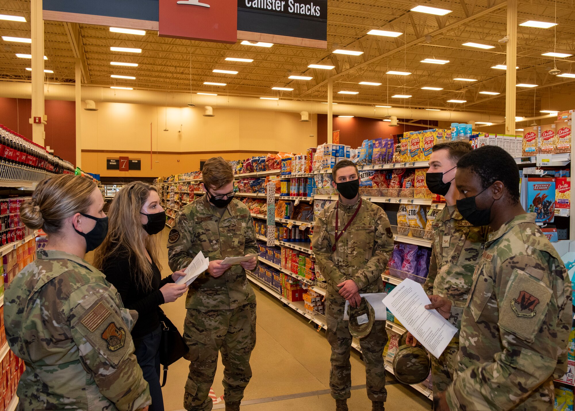 Sarah O’Neill, second from left, the 673d Operational Medical Readiness Squadron Health Promotion coordinator, talks to U.S. Airmen and Soldiers about healthy snack options during a Health Promotion-led Commissary tour at Joint Base Elmendorf-Richardson, Alaska, April 19, 2021. Health Promotion strives to promote health and wellness for all military members, their dependents, and Department of Defense civilians through community and group events to improve the health, mission readiness and productivity of the military community.