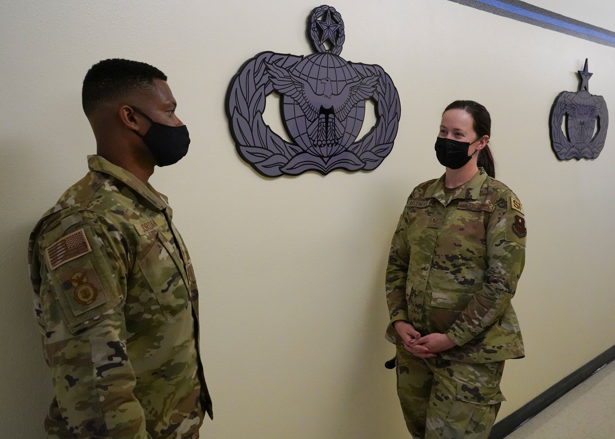 U.S. Air Force Senior Master Sgt. Travis Jordan, 81st Security Forces Squadron operation superintendent, helps Staff Sgt. Jessica Arceneaux, 81st SFS commander support staff NCO in charge inside the security forces building at Keesler Air Forces Base, Mississippi, April 29, 2021. Jordan serves as a mentor for the Airmen in his unit.
