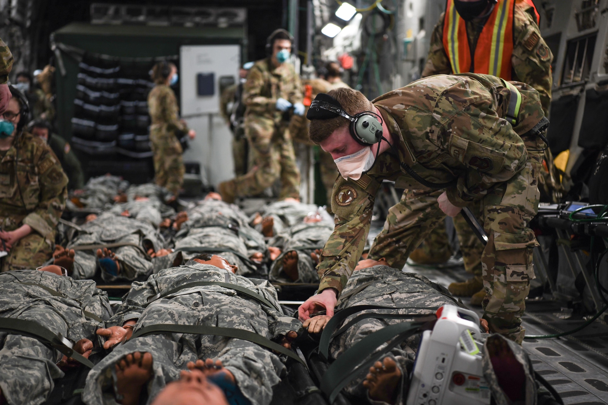 Senior Airman Nathan Boyer, 445th Aeromedical Evacuation Squadron, checks the vitals of patients on a 445th Airlift Wing C-17 Globemaster III during the Ultimate Caduceus training exercise April 29, 2021.  U.S. Transportation Command (USTRANSCOM) began a week-long aeromedical and global patient movement exercise, Ultimate Caduceus, April 26. Approximately 250 personnel including members of the 445th Airlift Wing and the 88th Air Base Wing participated in the field training exercise. (U.S. Air Force photo//Master Sgt. Patrick O’Reilly)