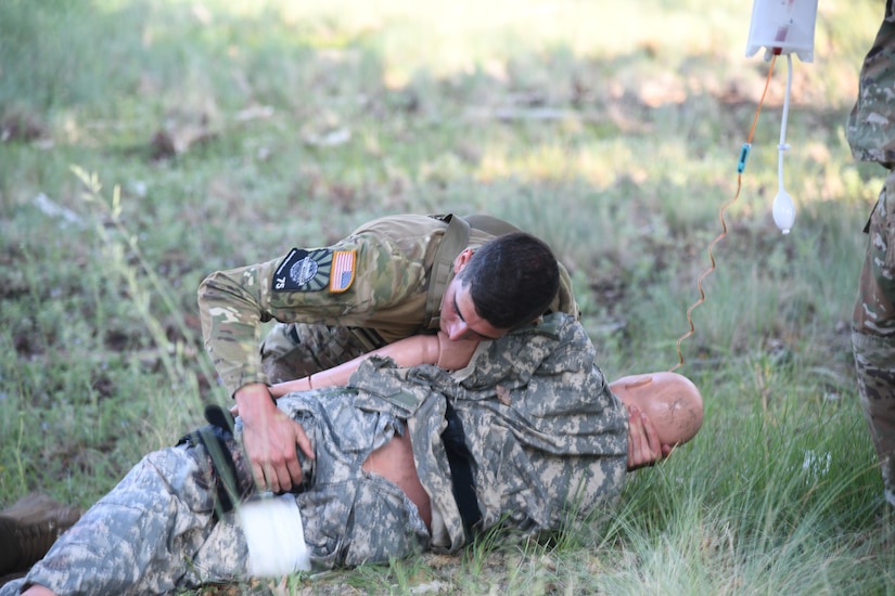Spc. Adam Barlow, from the 65th Field Artillery Brigade, Utah National Guard, evaluates and treats a simulated casualty July 20, 2021, during the U.S. Army National Guard Best Warrior Competition at Camp Navajo Military Reservation, Arizona.