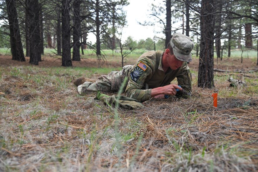Spc. Adam Barlow, from the 65th Field Artillery Brigade, Utah National Guard, sets up a simulated claymore mine July 21, 2021, during the U.S. Army National Guard Best Warrior Competition at Camp Navajo Military Reservation, Arizona.