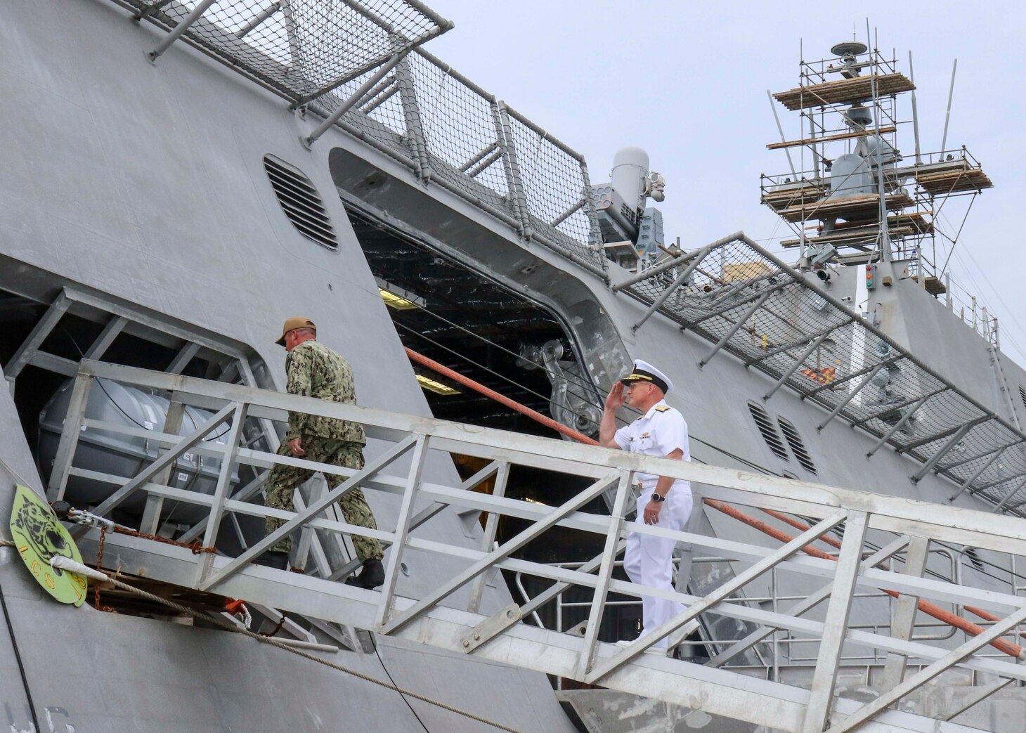 210730-N-JL294-1064 APRA HARBOR, Guam (July 30, 2021) Chief of Naval Operations (CNO) Adm. Mike Gilday, right, and Cmdr. Joseph Burgon come aboard Independence-variant littoral combat ship USS Charleston (LCS 18), July 30. Charleston, part of Destroyer Squadron Seven, is on a rotational deployment operating in the U.S. 7th Fleet area of operation to enhance interoperability with partners and serve as a ready-response force in support of a free and open Indo-Pacific region. (U.S. Navy photo by Mass Communication Specialist 2nd Class Adam Butler)