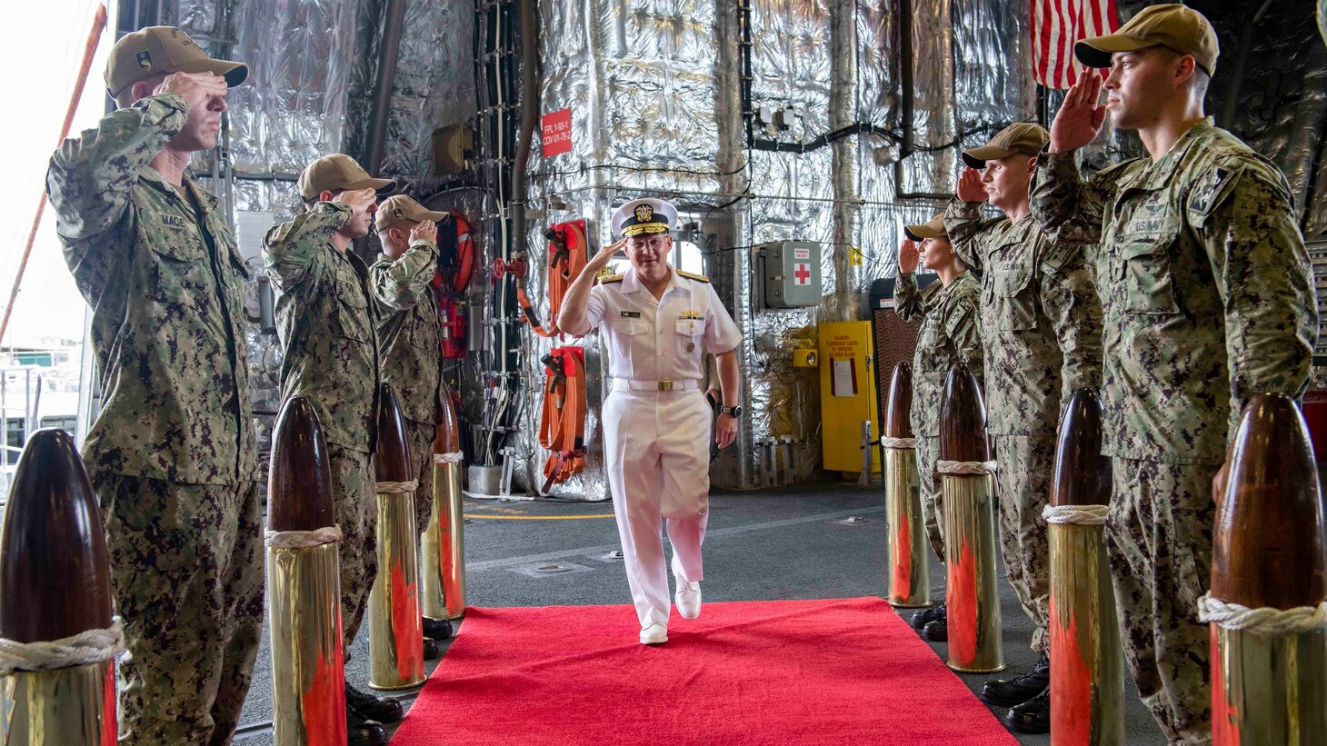 210730-N-WU807-1010 APRA HARBOR, Guam (July 30, 2021) Chief of Naval Operations (CNO) Adm. Mike Gilday, center, receives honors from Sideboys as he comes aboard Independence-variant littoral combat ship USS Charleston (LCS 18), July 30. Charleston, part of Destroyer Squadron Seven, is on a rotational deployment operating in the U.S. 7th Fleet area of operation to enhance interoperability with partners and serve as a ready-response force in support of a free and open Indo-Pacific region. (U.S. Navy photo by Mass Communication Specialist 2nd Class Adam Butler)