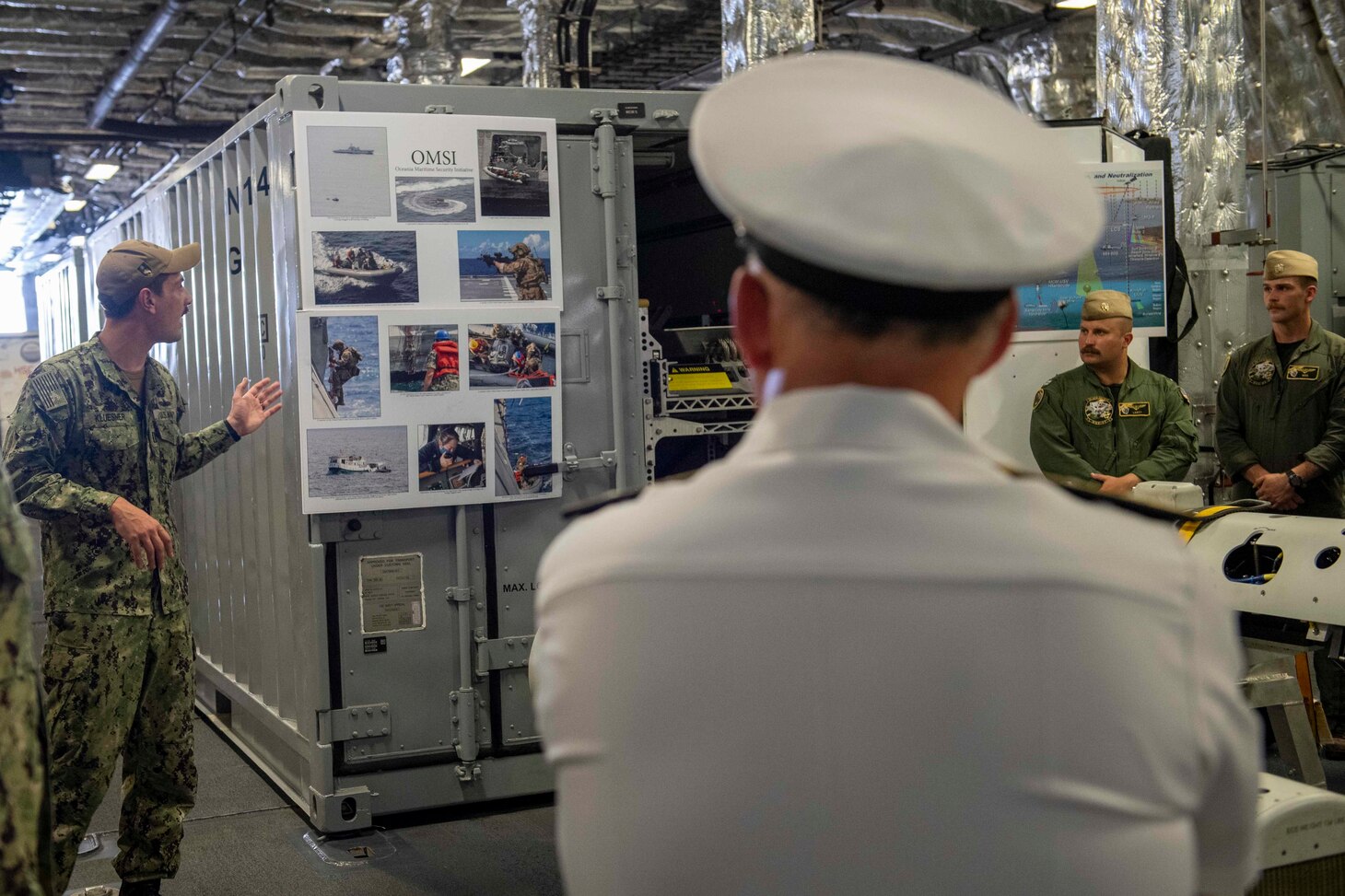 210730-N-WU807-1054 APRA HARBOR, Guam (July 30, 2021) Lt. James Kluesner, left, from Nevada, Iowa, explains LCS's role during Oceania Maritime Security Initiative (OMSI) mission to Chief of Naval Operations (CNO) Adm. Mike Gilday aboard Independence-variant littoral combat ship USS Charleston (LCS 18), July 30. Charleston, part of Destroyer Squadron Seven, is on a rotational deployment operating in the U.S. 7th Fleet area of operation to enhance interoperability with partners and serve as a ready-response force in support of a free and open Indo-Pacific region. (U.S. Navy photo by Mass Communication Specialist 2nd Class Adam Butler)