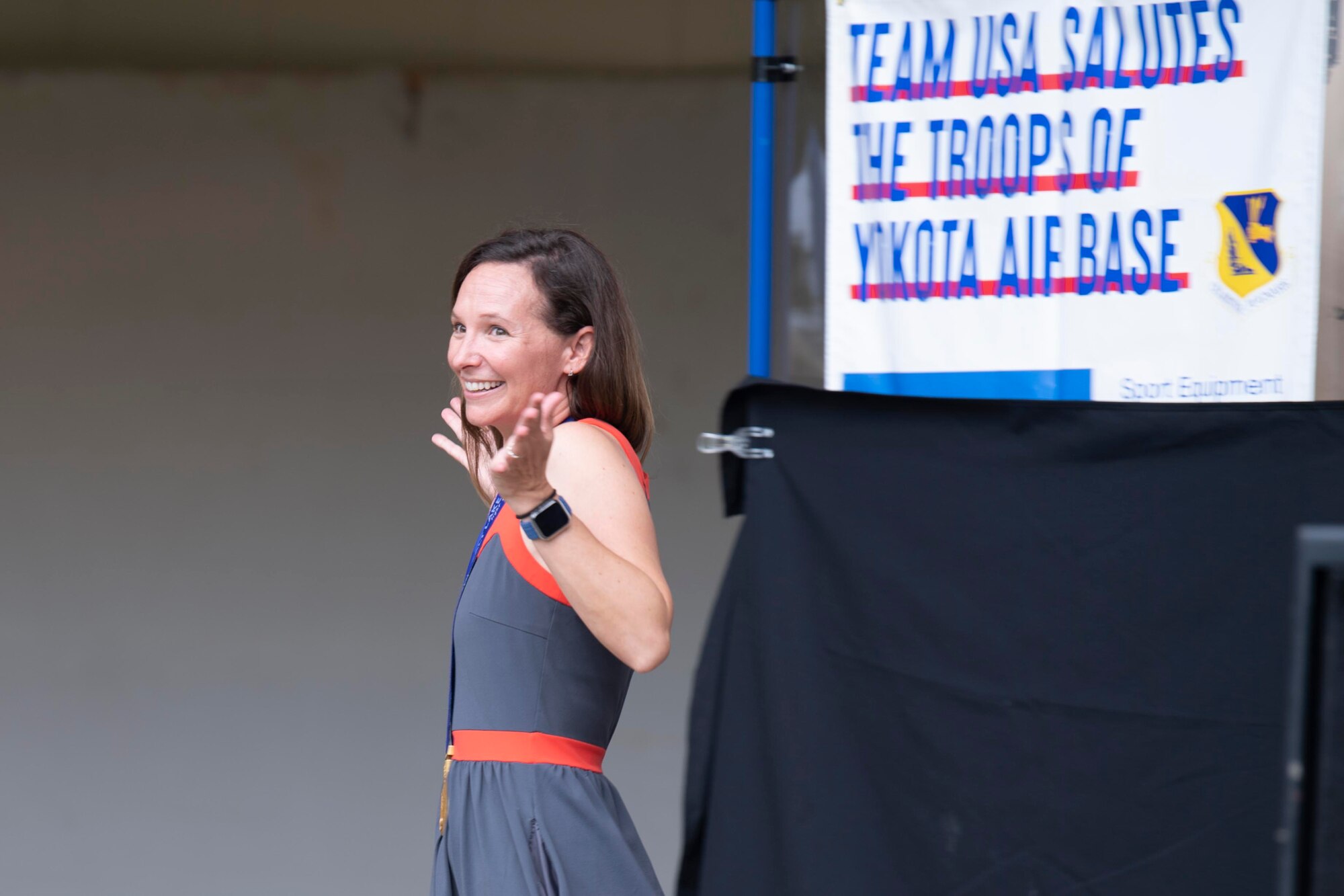 Tristan Gale, 2002 Olympic gold medalist, greets the crowd during the Olympic Salute at Yokota Air Base, Japan, July 30, 2021.
