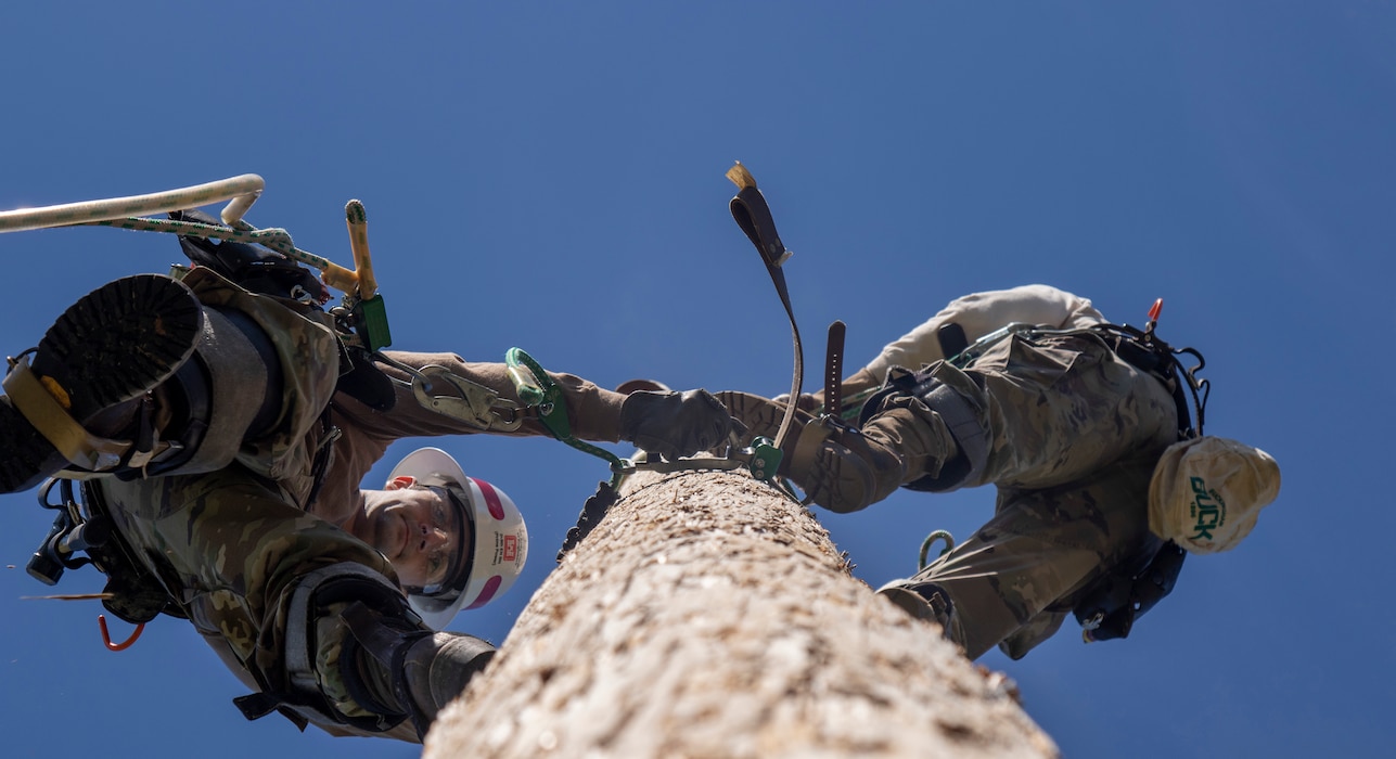 Soldiers from the 249th Engineer Battalion conduct a tandem climb up a power pole during a training exercise at Fort Belvoir Virginia on May 7, 2021.