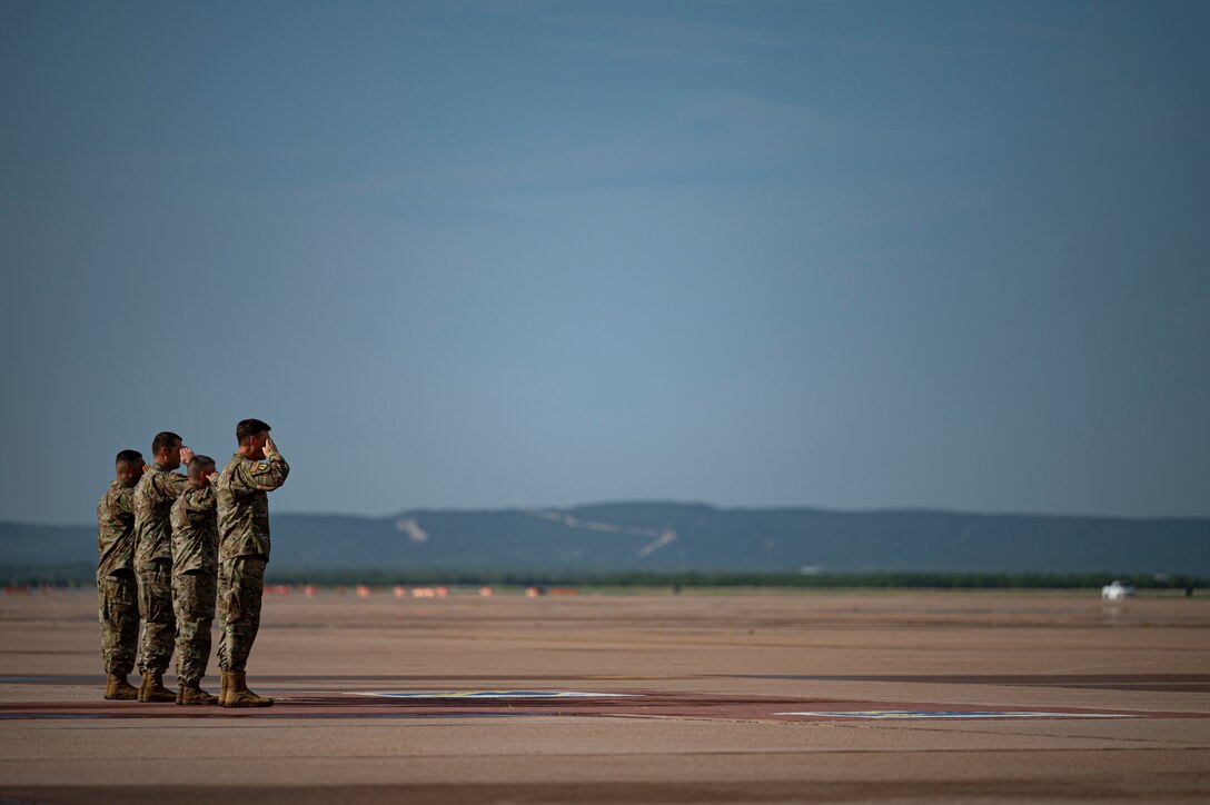 Leadership from the 317th Airlift Wing and 7th Bomb Wing salute during the arrival of U.S. Army Gen. Stephen R. Lyons, U.S. Transportation Command commander, at Dyess Air Force Base, Texas, July 28, 2021. Lyons toured the 39th Airlift Squadron and recognized some of the star performers from the squadron’s most recent deployment. (U.S. Air Force photo by Senior Airman Colin Hollowell)