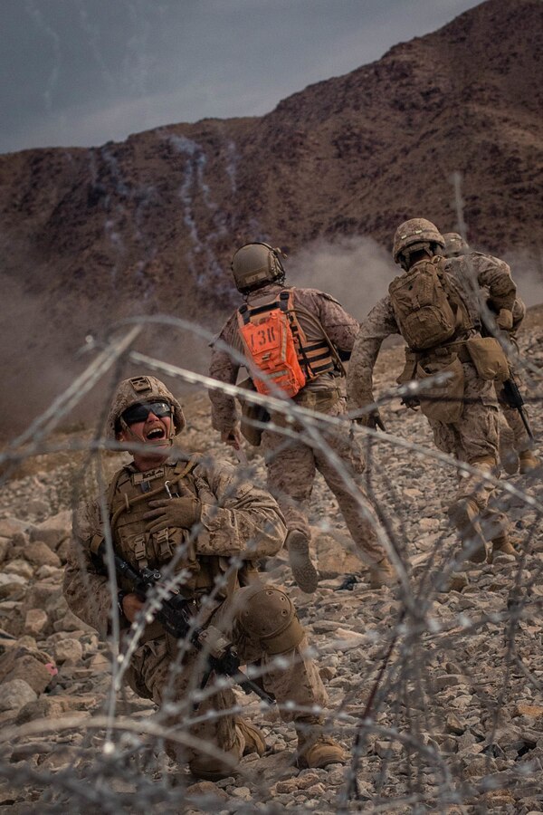 Marines with Fox Company, 2nd Battalion, 23rd Marines, 4th Marine Division, maneuver through cut concertina wire on Range 410A during Integrated Training Exercise (ITX) 4-21 at Marine Corps Air Ground Combat Center, Twentynine Palms, California on July 31st, 2021. Range 410A provides Reserve Marines the opportunity to execute a fire and maneuver attack supported by mortarmen, machine gunners and combat engineers. (U.S Marine Corps photo by Lance Cpl. David Intriago)