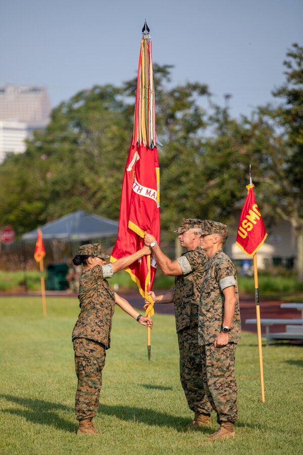 Sgt. Maj. Lynnette Marr-Gaye, sergeant major, 4th Marine Aircraft Wing, presents the wing’s colors during the 4th MAW change of command ceremony at Marine Corps Support Facility New Orleans on July 30, 2021. 4th MAW is the air combat element for Marine Forces Reserve and integrates three core capabilities in support of the Marine Corps' Total Force: aircraft operations, aviation ground support and aviation command and control. (U.S. Marine Corps photo by Lance Cpl. Mitchell Collyer)