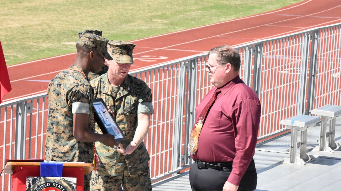 Arnold Engineering Development Complex senior engineer, Technical Management, Michael Glennon, right, is recognized by Col. Jeffrey Johnson, center, for his mentorship of the Tullahoma High School Marnie Corps Junior ROTC CyberPatriot program during the May 6, 2021, THS MCJROTC Awards Assembly. For more than eight years, Glennon has mentored CyberPatriot programs in communities around Arnold Air Force Base, headquarters of AEDC. Also pictured is MCJRTOC cadet Travis Simons. (U.S. Air Force photo by Bradley Hicks)
