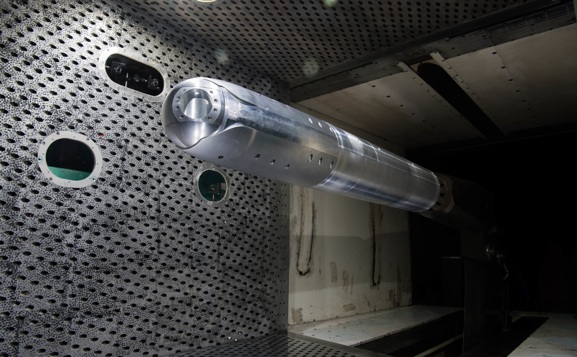 A directed energy (DE) system turret is positioned on a sting in the 4-foot transonic wind tunnel at Arnold Air Force Base for testing by the Aerodynamics Test Branch of Arnold Engineering Development Complex, March 5, 2021. Wind tunnel testing allows system developers to see the impact of airflow disturbances on the DE beam. (U.S. Air Force photo by Jill Pickett)
