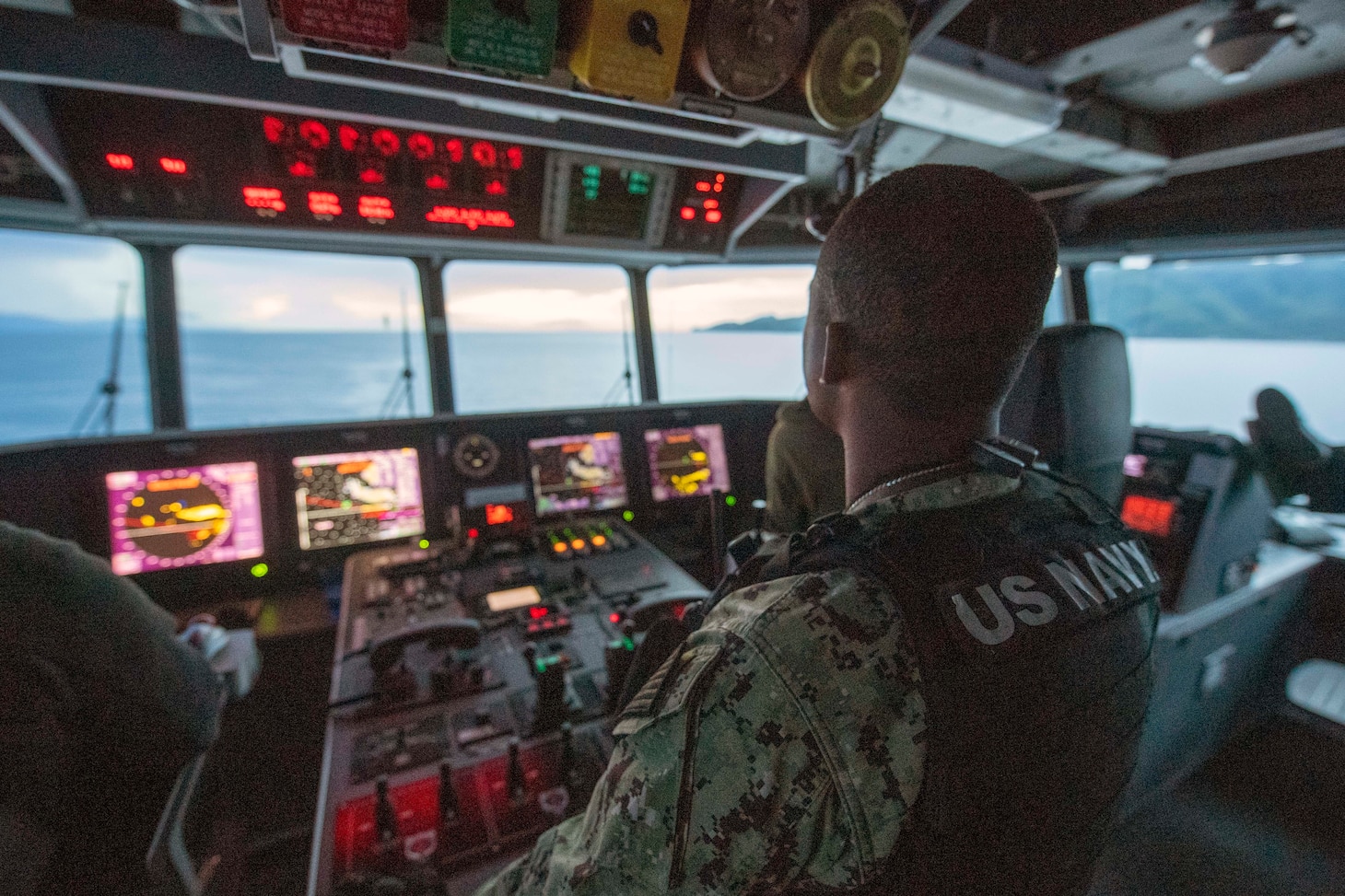 Chief Master-at-Arms Cornelius Johnson stands watch on the bridge aboard the Spearhead-class expeditionary fast transport USNS City of Bismarck (T-EPF-9).