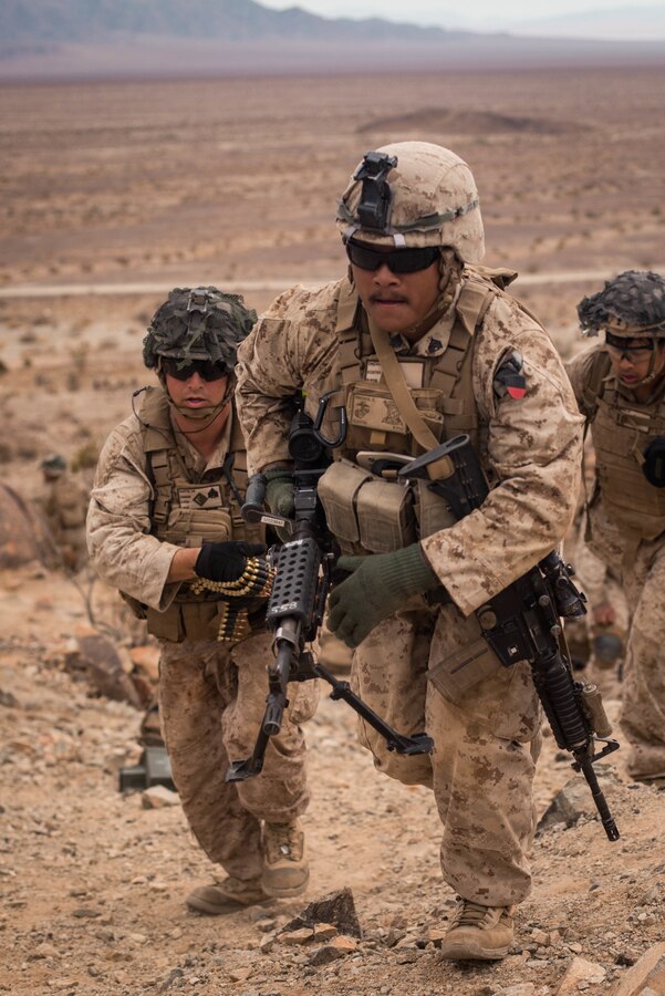 Sgt. Kroeksak Onchan, a squad leader with Echo Company, 2nd Battalion, 23rd Marines, leads his Marines into position on Range 410A during Integrated Training Exercise (ITX) 4-21 at Marine Corps Air Ground Combat Center, Twentynine Palms, California on July 30th, 2021. Range 410A provides Reserve Marines the opportunity to execute a fire and maneuver attack supported by mortarmen, machine gunners and combat engineers. (U.S Marine Corps photo by Lance Cpl. David Intriago)