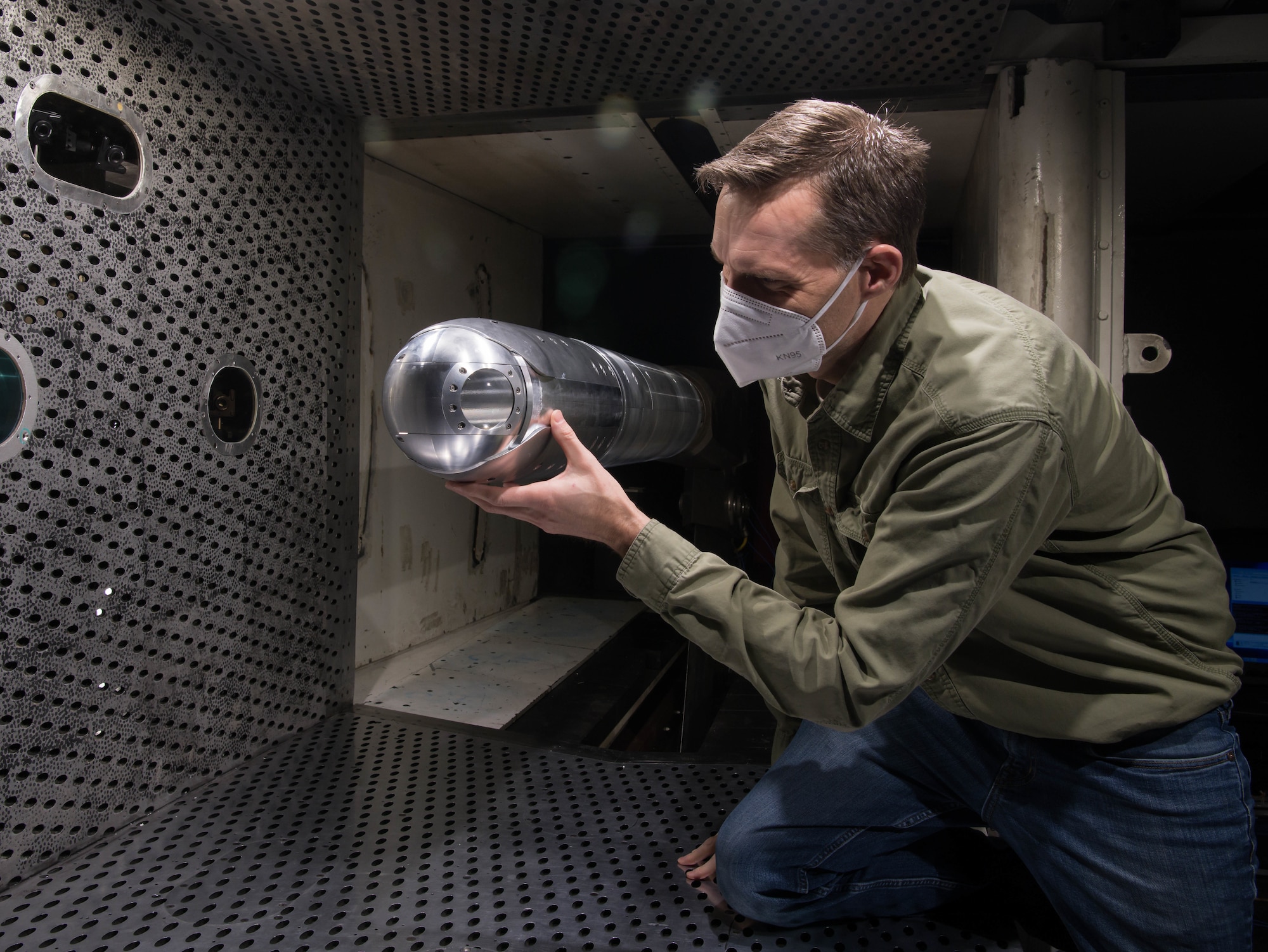 Dr. Rich Roberts, chief of the Aerodynamics Branch Store Separation Section of Arnold Engineering Development Complex, looks at a directed energy (DE) system turret positioned on a sting in the 4-foot transonic wind tunnel at Arnold Air Force Base, Tenn., March 5, 2021. The branch plans to expand DE wind tunnel testing capabilities later this year with the addition of the Integrated Directed Energy Aero-Optical Surrogate, which is a subscale model of an F-15 aircraft with the ability to test laser pods. (U.S. Air Force photo by Jill Pickett)