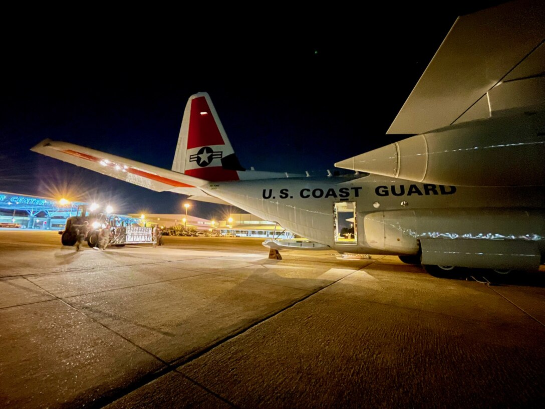 With the help of the Air National Guard’s 164th Logistics Readiness Squadron, a U.S. Coast Guard HC-130 Hercules crew from Elizabeth City, N.C., loads the plane with 500,000 doses of the COVID vaccine in Memphis on July 14, 2021. This delivery was received by a U.S. embassy team in Haiti under the COVAX program on behalf of the U.S. Health and Human Services — a gift from the American people to the people of Haiti.