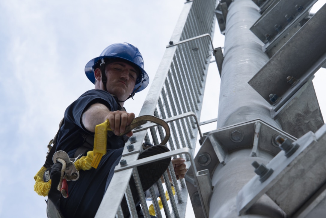 Coast Guard Fireman Carson DeZenzo of the Coast Guard Aids to Navigation Team from Sector St. Petersburg works on the Big Bend inbound range rear light, Gibsonton, Florida, July 27, 2021. ATON teams ensure maritime aids to navigation under their care are functioning properly so recreational and commercial mariners can safely navigate the maritime environment