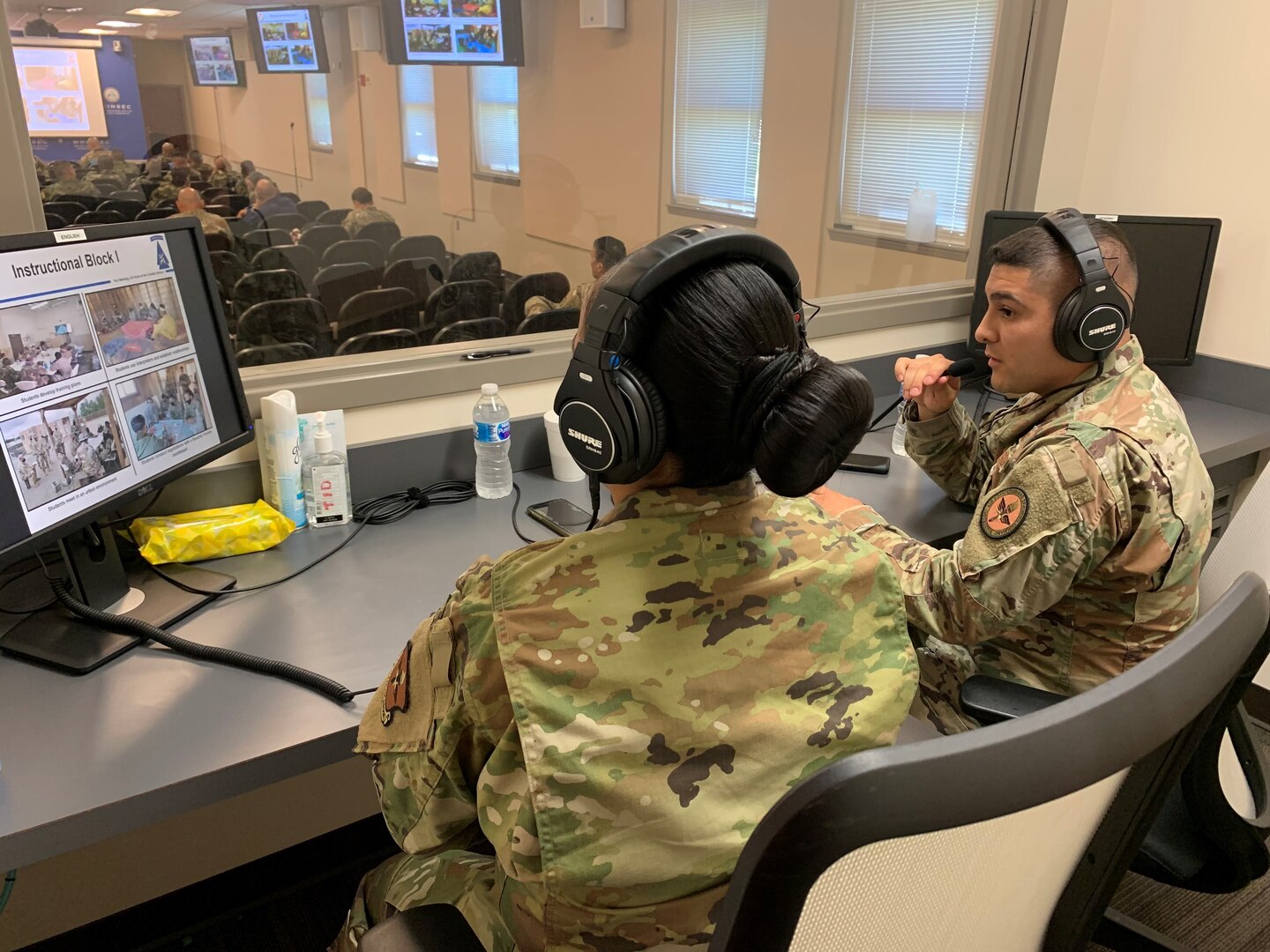 Two Air Force NCOs sitting at computer console.