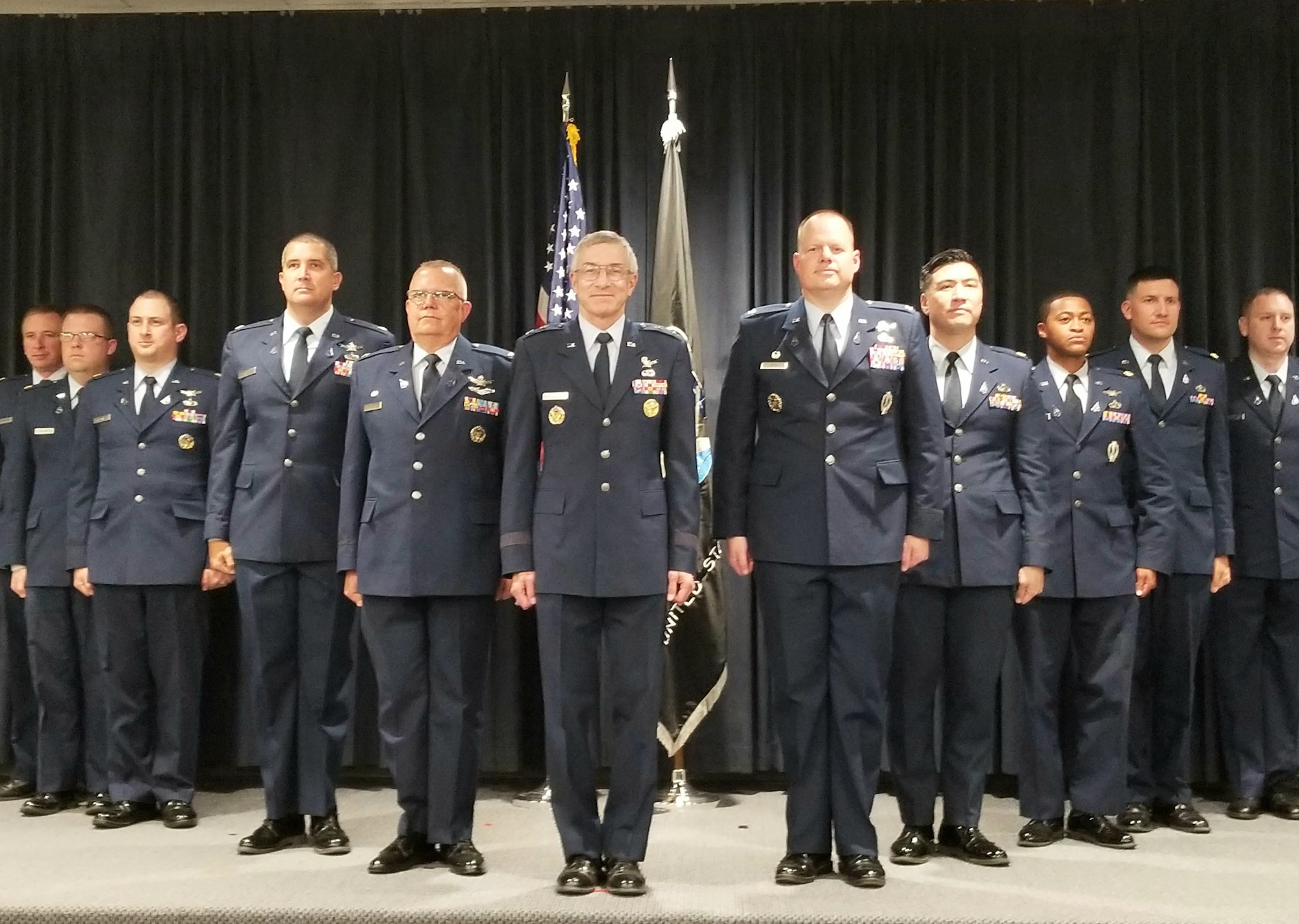 Ten officers from the Air Force Research Laboratory and Space and Missile Systems Center space units at Kirtland AFB, N.M. were inducted into the U.S. Space Force in a ceremony held at Kirtland July 23. Maj. Gen. Neil McCasland (USAF Ret.), center, officiated the ceremony. (U.S. Air Force photo/Joanne Perkins)