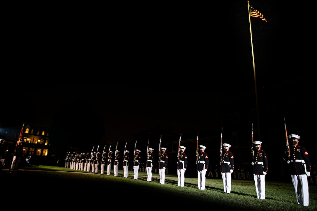 Marines with the Silent Drill Platoon execute their “long line” sequence during the Friday Evening Parade at Marine Barracks Washington, July 30, 2021. The guest of honor for the evening was The Honorable Kathleen H. Hicks, 35th Deputy Secretary of Defense, and the hosting official was Gen. David H. Berger, 38th Commandant of the Marine Corps. (U.S. Marine Corps photo by Lance Cpl. Tanner D. Lambert)