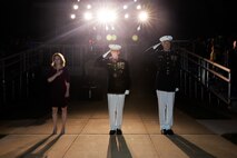 From left, The Honorable Kathleen H. Hicks, 35th Deputy Secretary of Defense, Gen. David H. Berger, 38th Commandant of the Marine Corps, and Col. Teague A. Pastel, commanding officer, Marine Barracks Washington, stand at the position of attention and render a salute during “honors” for the Friday Evening Parade at MBW, July 30, 2021.