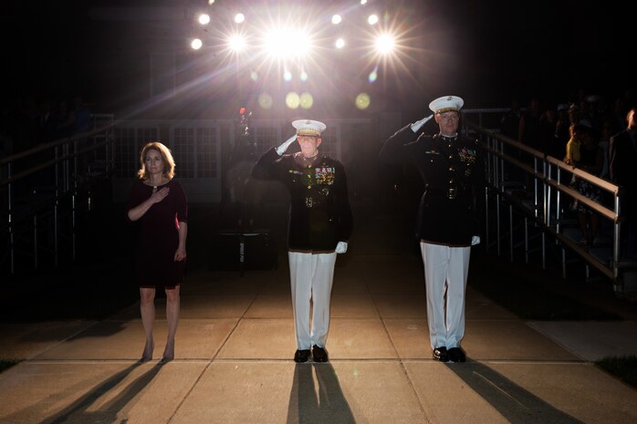 From left, The Honorable Kathleen H. Hicks, 35th Deputy Secretary of Defense, Gen. David H. Berger, 38th Commandant of the Marine Corps, and Col. Teague A. Pastel, commanding officer, Marine Barracks Washington, stand at the position of attention and render a salute during “honors” for the Friday Evening Parade at MBW, July 30, 2021.