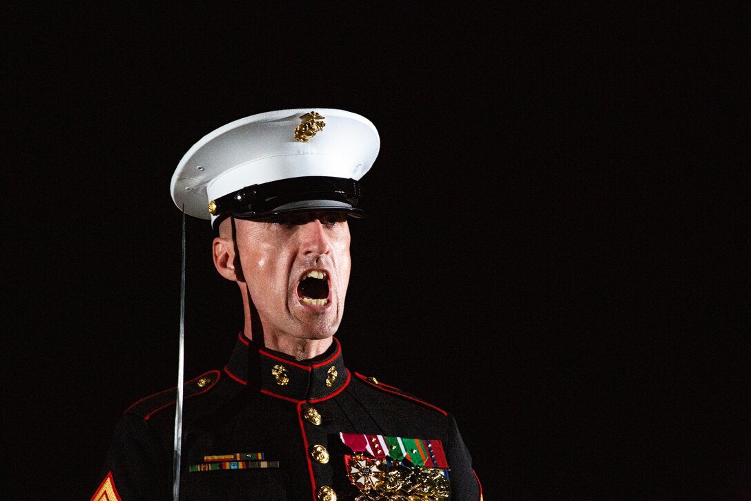 Sergeant Maj. Adrian Tagliere, sergeant major, Marine Barracks Washington, issues commands during the Friday Evening Parade at MBW, July 30, 2021.