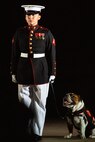 Lance Cpl. Rebekah Macias, mascot handler, Marine Barracks Washington, stands on Center Walk with the official Marine Corps mascot, Lance Cpl. Chesty XV, during the Friday Evening Parade at MBW, July 30, 2021.