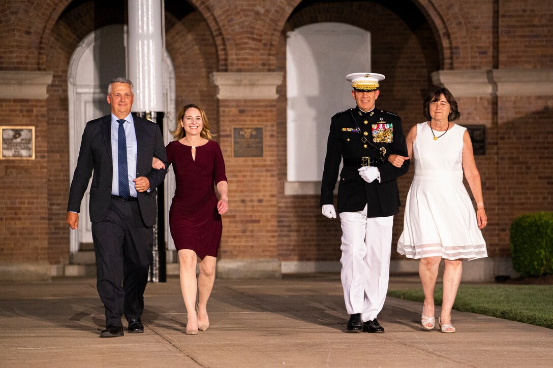 The Honorable Kathleen H. Hicks, 35th Deputy Secretary of Defense, accompanied by her husband, and Gen. David H. Berger, 38th Commandant of the Marine Corps, accompanied by his wife, walk down Center Walk during the Friday Evening Parade at Marine Barracks Washington, July 30, 2021.