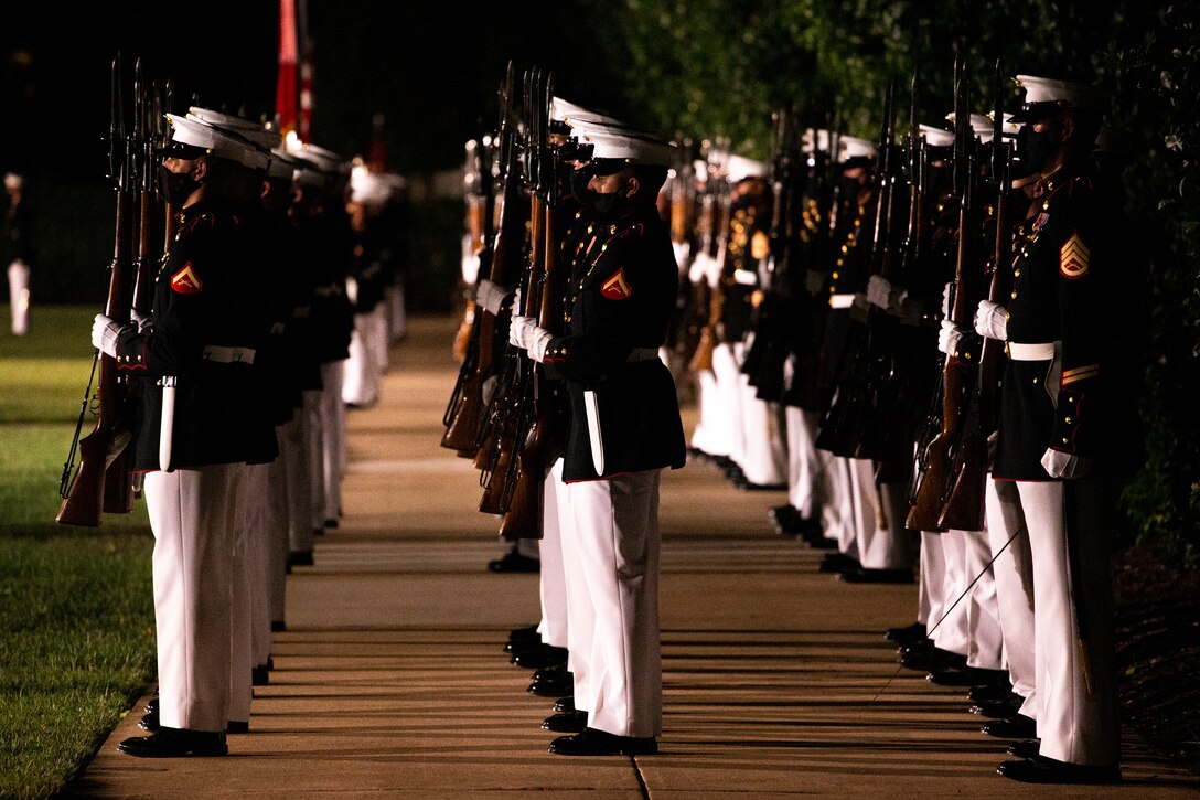 Marines with Marine Barracks Washington execute “present arms” during the Friday Evening Parade at MBW, July 30, 2021.