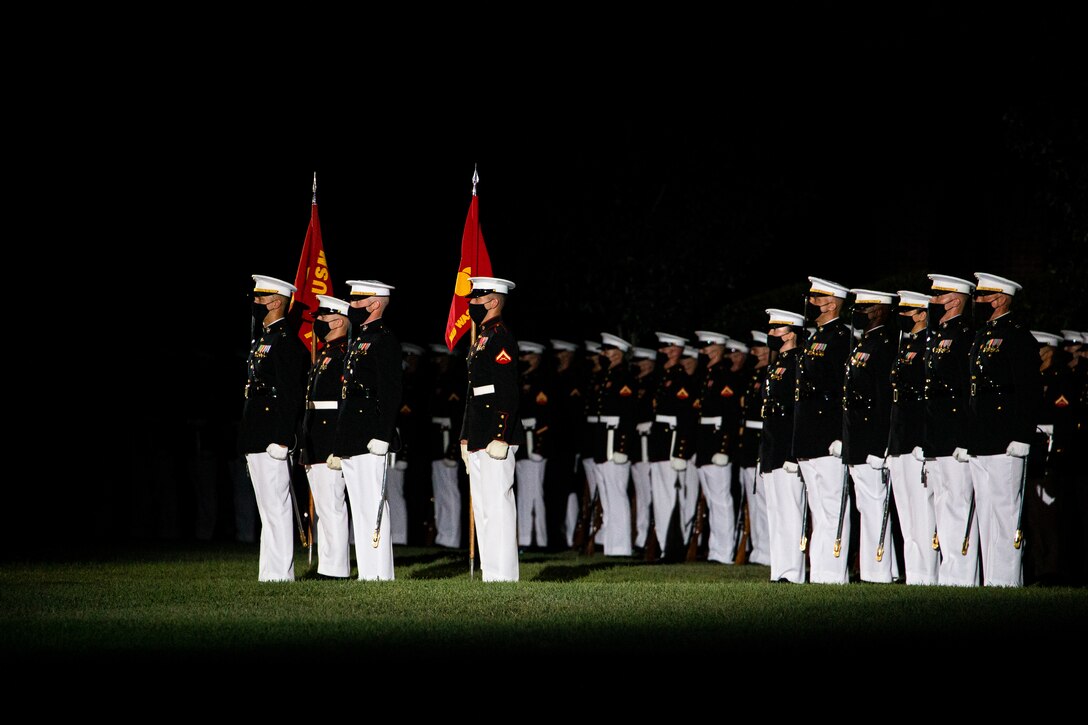 Marines with Marine Barracks Washington conduct “officers center” during the Friday Evening Parade at MBW, July 30, 2021. The guest of honor for the evening was The Honorable Kathleen H. Hicks, 35th Deputy Secretary of Defense, and the hosting official was Gen. David H. Berger, 38th Commandant of the Marine Corps. (U.S. Marine Corps photo by Lance Cpl. Allen T. Sanders)