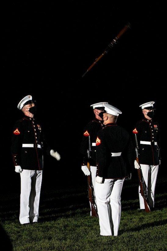 Marines with the Silent Drill Platoon execute their “rifle inspection” sequence during the Friday Evening Parade at Marine Barracks Washington, July 30, 2021.