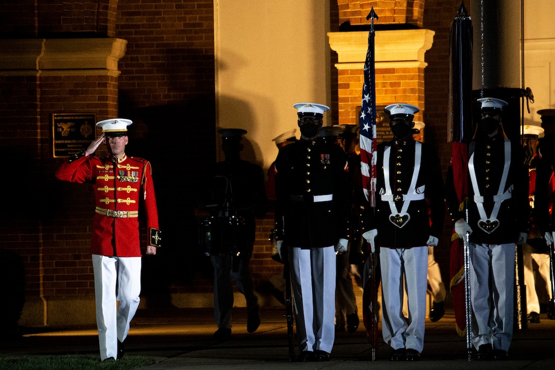 Captain Nathan D. Morris, assistant director, “The Commandant’s Own,” U.S. Marine Drum and Bugle Corps, salutes the national ensign during the Friday Evening Parade at Marine Barracks Washington, July 30, 2021. The guest of honor for the evening was The Honorable Kathleen H. Hicks, 35th Deputy Secretary of Defense, and the hosting official was Gen. David H. Berger, 38th Commandant of the Marine Corps. (U.S. Marine Corps photo by Lance Cpl. Allen T. Sanders)