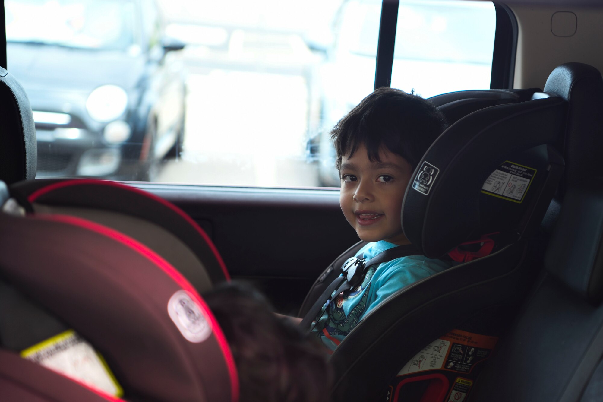 A child waits for school items during the Back-to-School Bash July 21, 2021, at Gila River Arena in Glendale, Arizona.