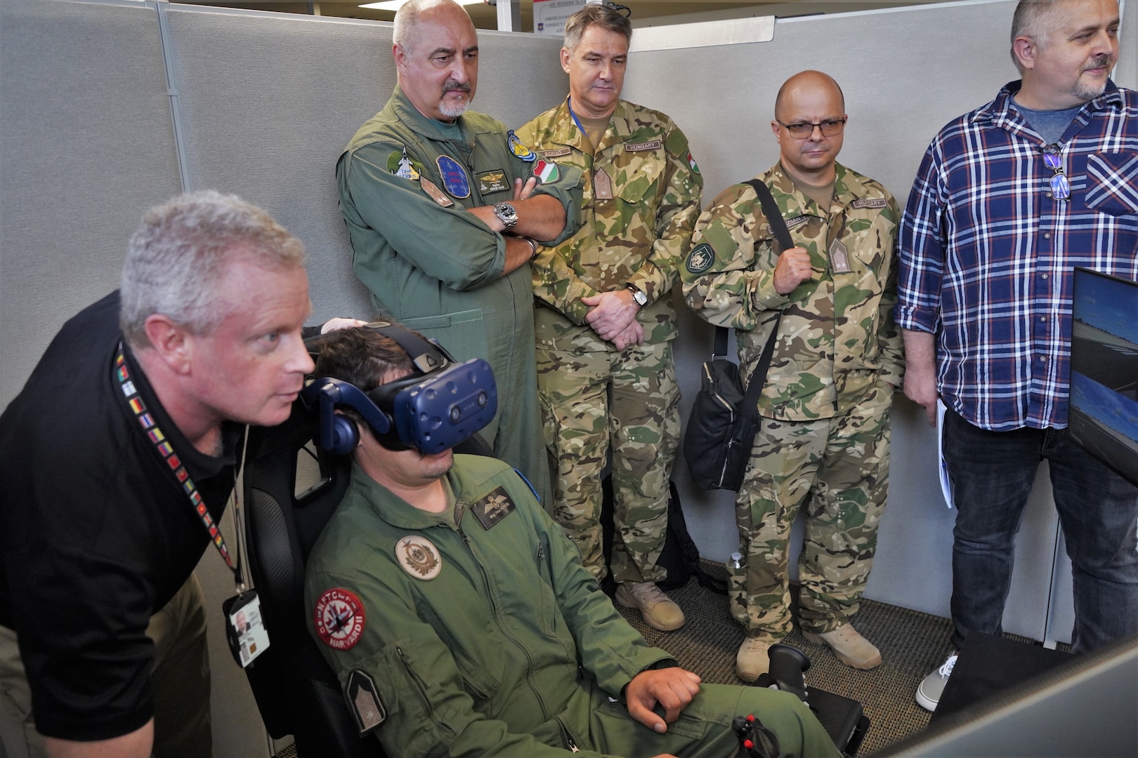 Hungarian Air Force members view flight simulator at DLIELC.