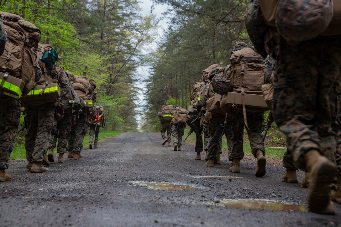 U.S. Marines with Headquarters and Service Battalion, U.S. Marine Corps Forces Command, hike to landing zone Thrush at Quantico, Virginia, April 21, 2021. During the field training exercise, Marines conducted land navigation and close, long and unknown distance shooting while building squad level operational cohesion. (U.S. Marine Corps photo by Sgt. Kealii De Los Santos)