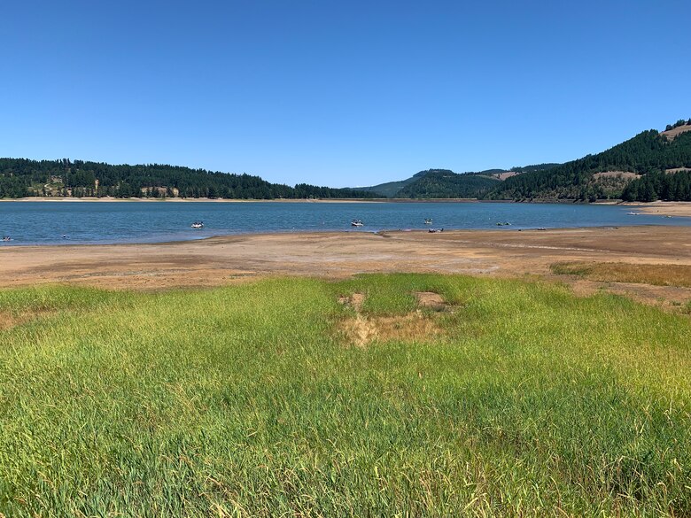 Cottage Grove Reservoir is 24% full, which is 76% less than what it should be as of Aug. 2, 2021 (photo taken July 20).

Nearly 50 days without measurable rain, combined with hot, dry conditions, has made reservoir levels in the Willamette Valley the lowest in six years. Additionally, forecasts are not predicting enough precipitation to alleviate the ongoing drought in the Pacific Northwest.