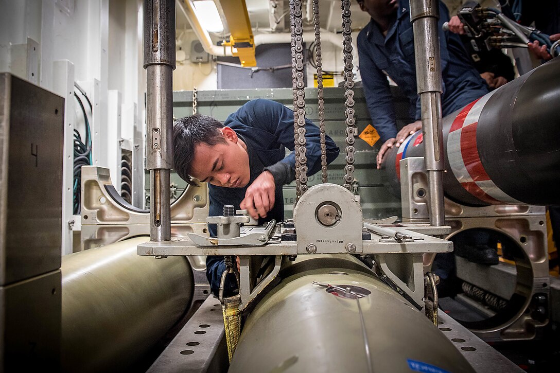 Sailors Hoist Torpedos