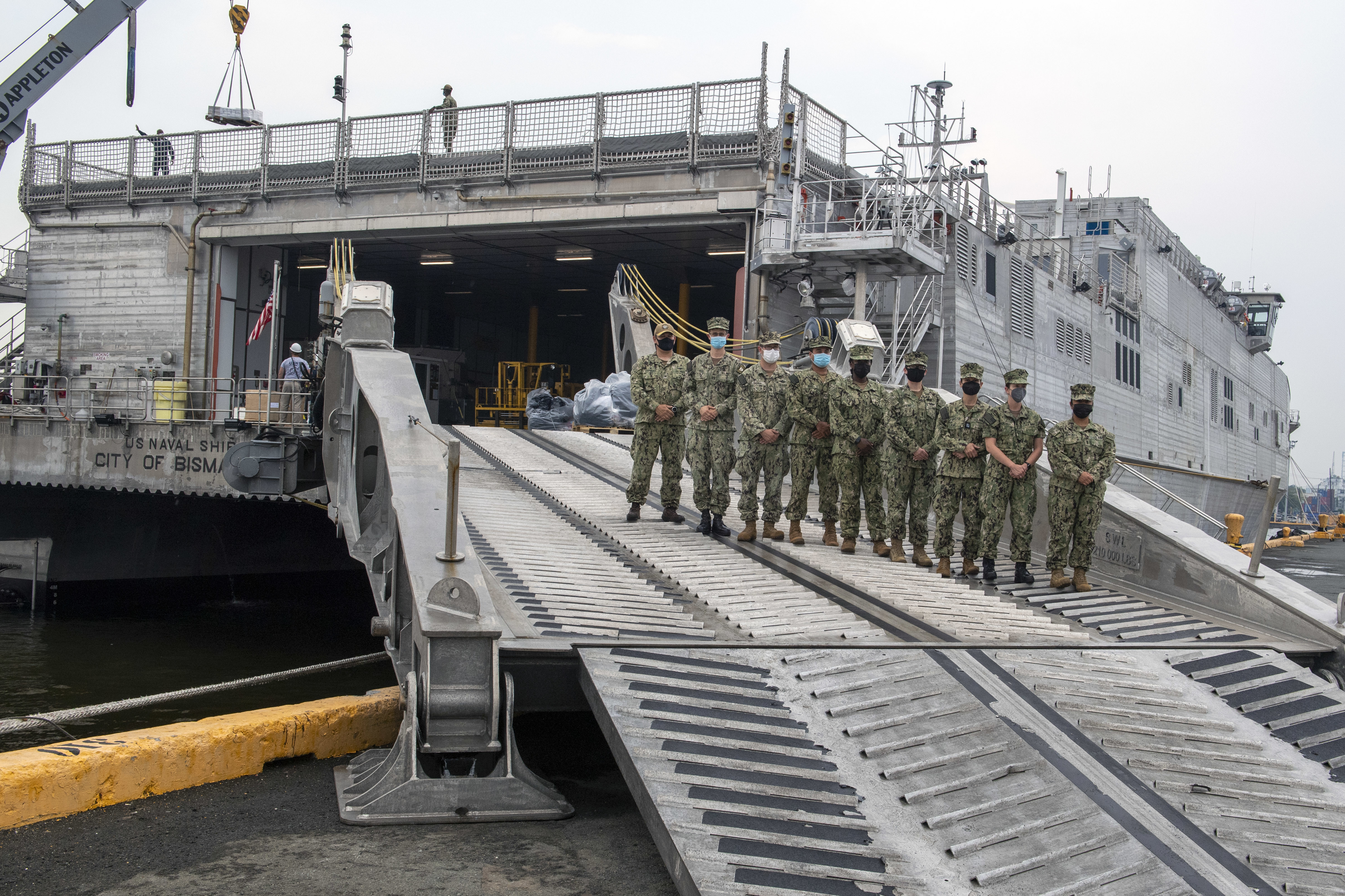 The Pacific Partnership 2021 team, led by Capt. Jesus Rodriguez, disembark the Spearhead-class expeditionary fast transport USNS City of Bismarck (T-EPF-9).