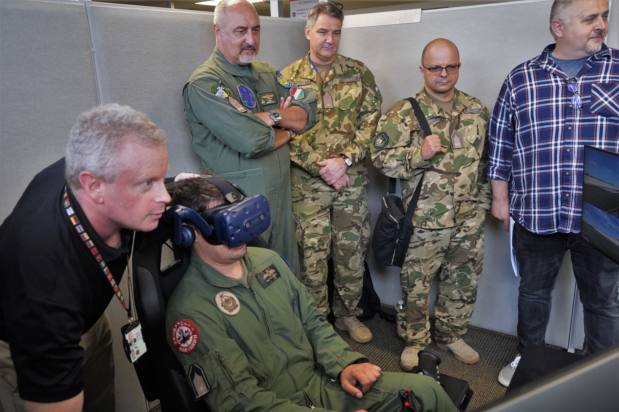 Hungarian Air Force members view flight simulator at DLIELC.