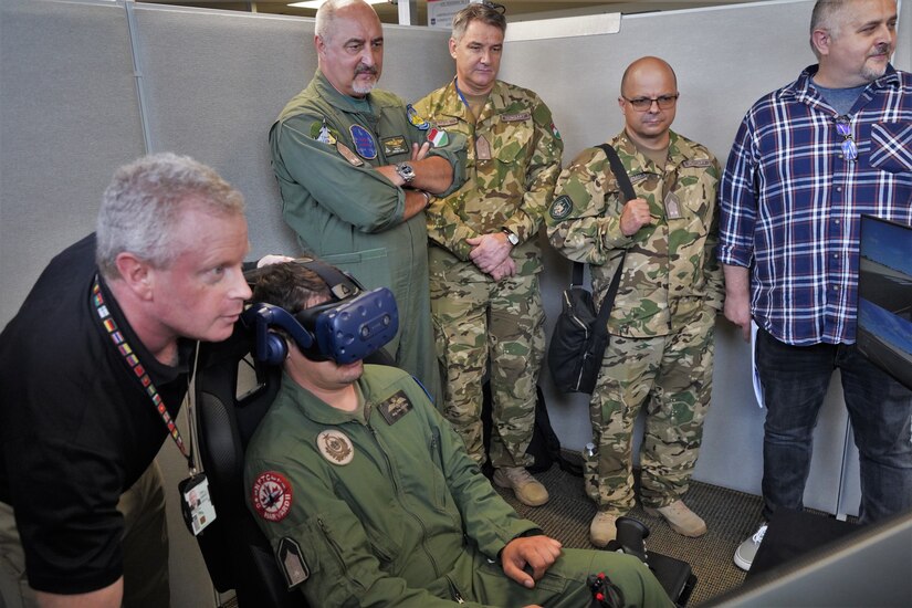 Hungarian Air Force members view flight simulator at DLIELC.