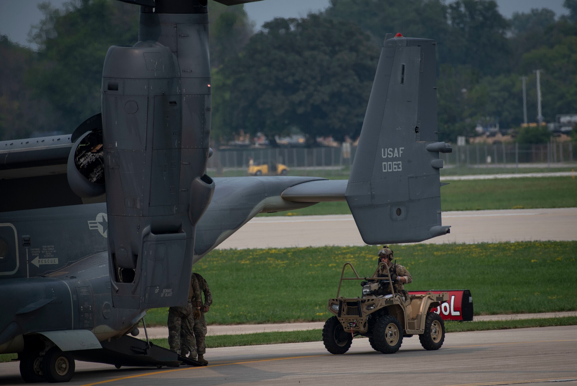 A U.S. Air Force special tactics Airman assigned to Air Force Special Operations Command loads onto a CV-22 Osprey after completing a personnel recovery demonstration at Wittman Regional Airport, Wis., July 29, 2021.