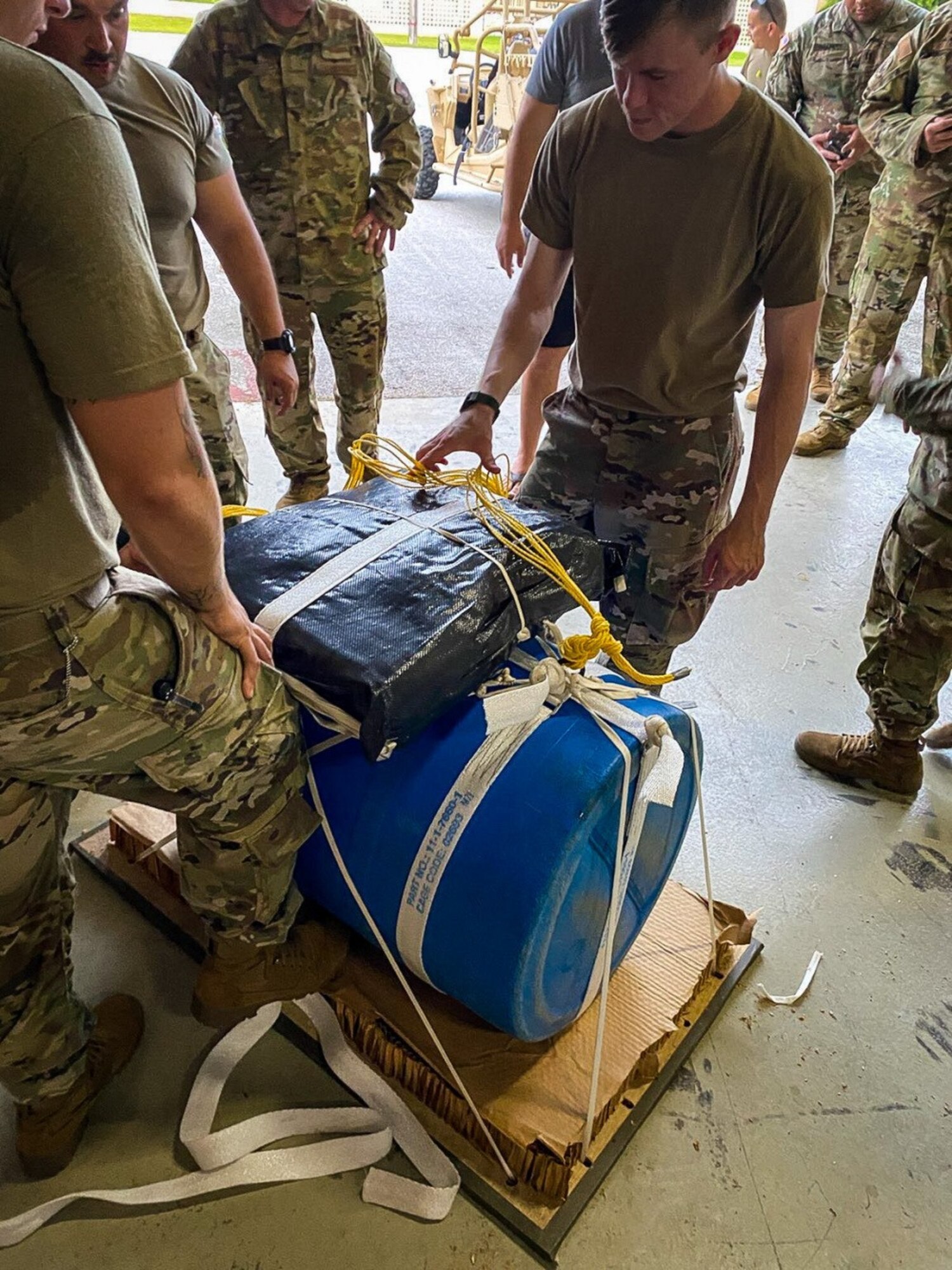 A crew comprised of U.S. Army parachute riggers with Group Support Battalion, 1st Special Forces Group (Airborne), 82nd Airborne Division, and a parachute rigger assigned to U.S. Navy Special Warfare Command built and apparatus at Andersen Air Force Base, Guam, to deliver medical supplies to an injured service member aboard a vessel out at sea, July 25, 2021.  The parachute riggers are currently supporting exercise Forager 21, which is a U.S. Army Pacific exercise designed to exercise Joint-integrated operations just like this rescue mission was.