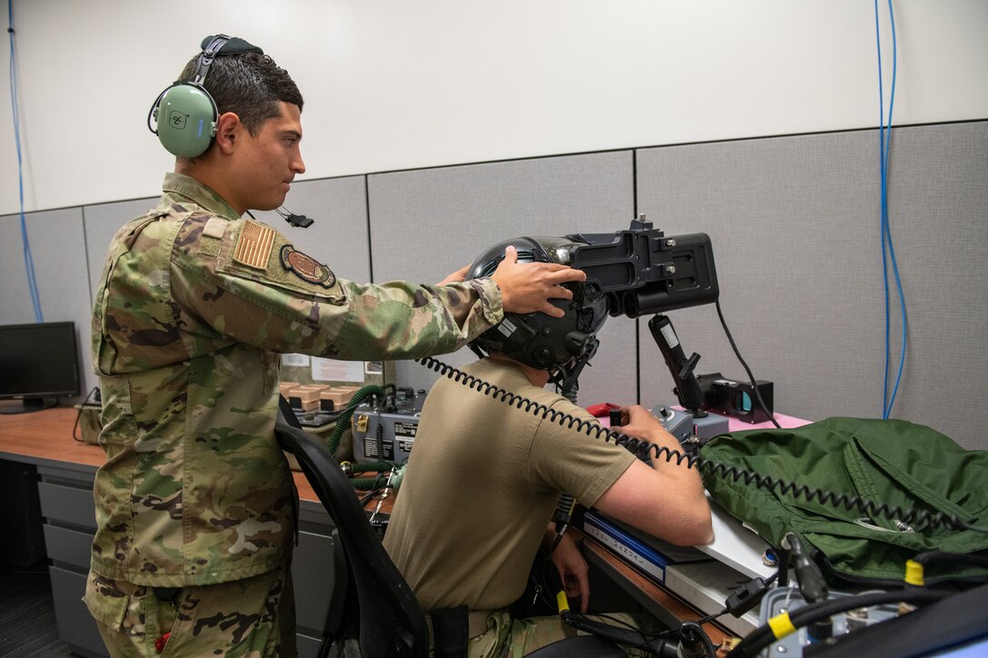 U.S. Air Force Staff Sgt. AJ Arteaga, 419th Operations Support Squadron, adjusts the head position of Tech. Sgt. Anthony Farnsworth, 419th OSS, during F-35 helmet optical fit training at Hill Air Force Base, Utah, on July 10, 2021. Reservists in the 419th OSS are responsible for maintaining and repairing pilot gear to ensure it is in proper working condition.
