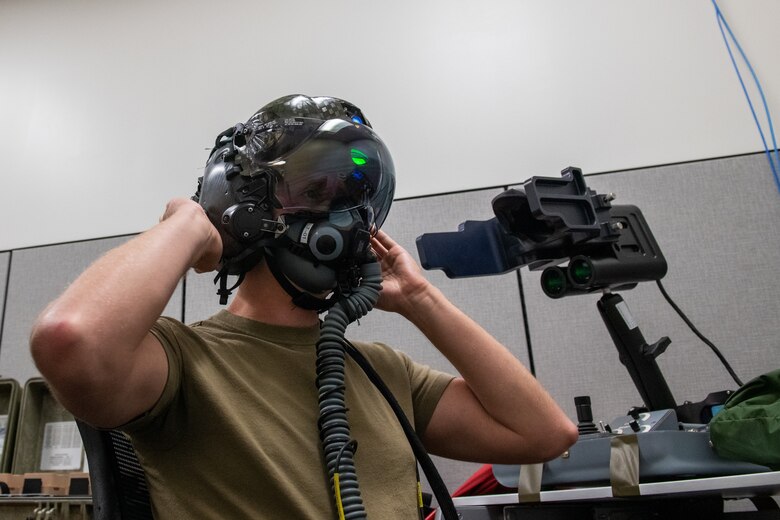 U.S. Air Force Tech. Sgt. Anthony Farnsworth, 419th Operations Support Squadron, adjusts an F-35 helmet during optical fit training at Hill Air Force Base, Utah, on July 10, 2021. Each helmet is inspected every 105 days and has a 120-day fit check to ensure its functionality and safety.